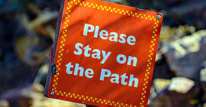 Please stay on the path sign